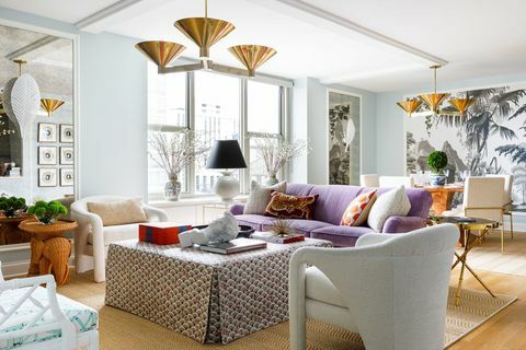 lila kanapé, nappali, világoskék festett falak, fehér kanapé székek, arany függő medálok